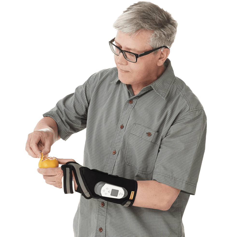 Man wears Rehabtronics Regrasp rehabilitation glove to help him peel an orange